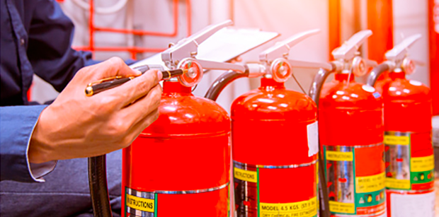 Picture4 A person is using a pair of scissors to cut the fire extinguisher.